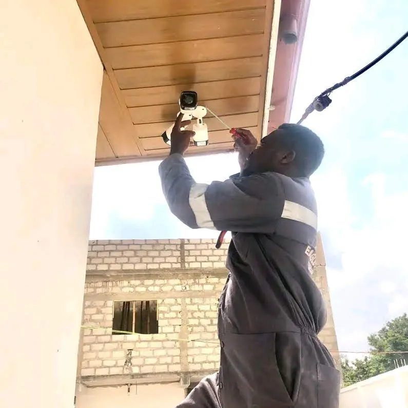 Technician installing a CCTV camera on a ceiling